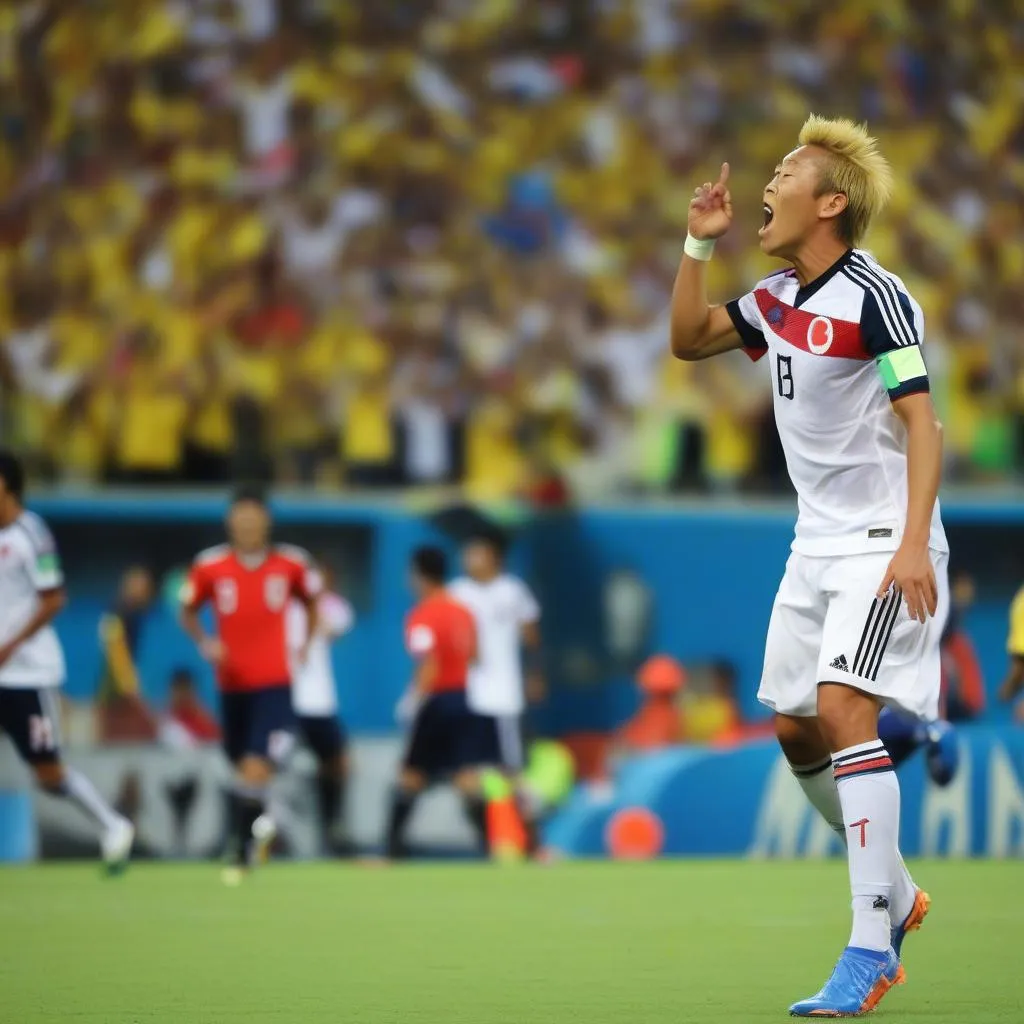 Keisuke Honda celebrates after scoring a penalty kick for Japan against Colombia in the 2014 World Cup